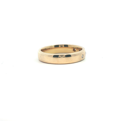 9k yellow gold band with four flush diamonds